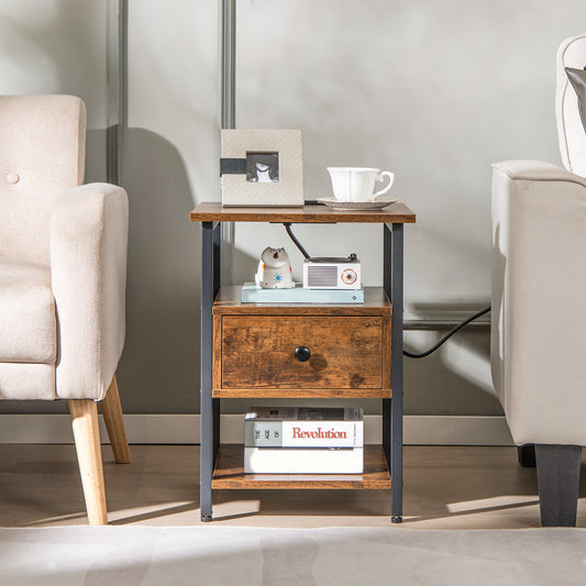 The nightstand placed between two armchairs in a living room with decorative items on the shelves