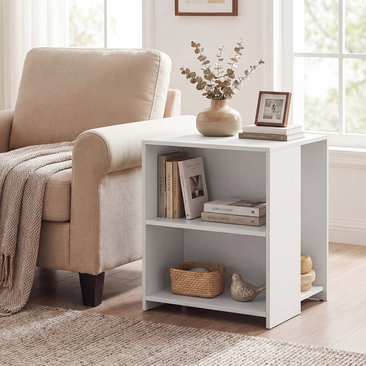 The white wooden end table is shown next to a beige armchair in a living room setting