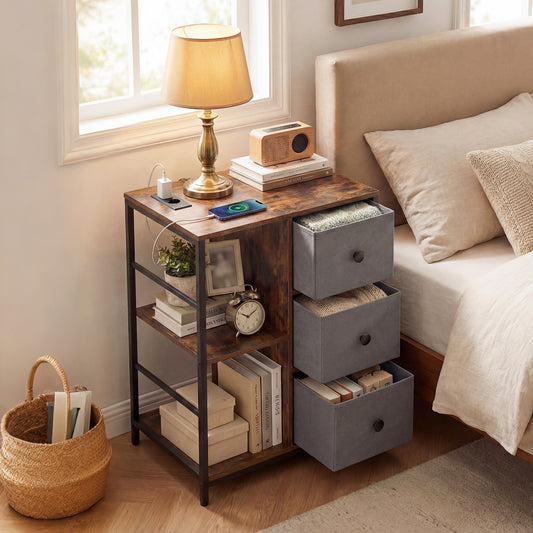 Rustic brown three-tier storage cabinet with charging hub next to a bed, showing items on shelves and in drawers
