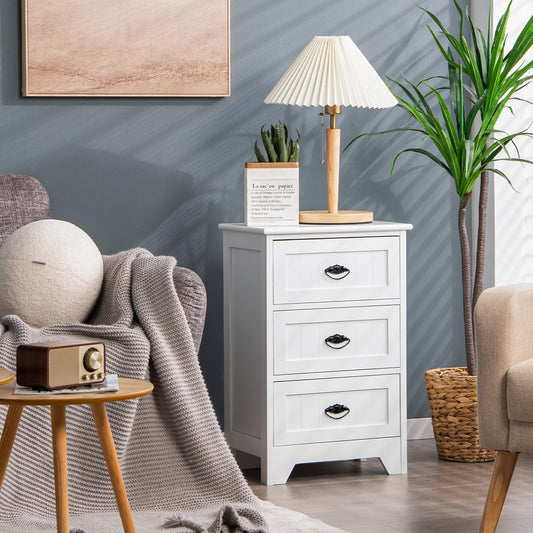 The white three-drawer nightstand is placed next to a bed in a bedroom setting