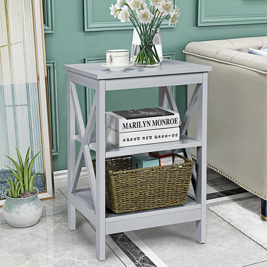 Grey wooden side table with books and a basket in a living room setting