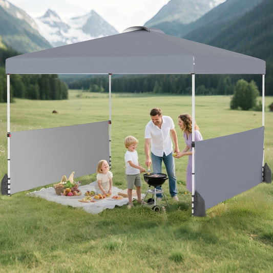 The grey pop up canopy tent with two half sidewalls being used for a garden barbecue
