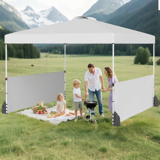 The white canopy tent is set up in a garden with a family having a barbecue