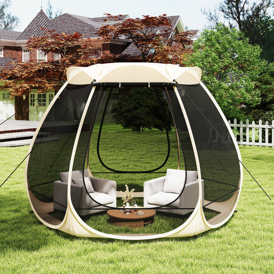 The camping tent gazebo set up in a garden with two armchairs and a coffee table inside