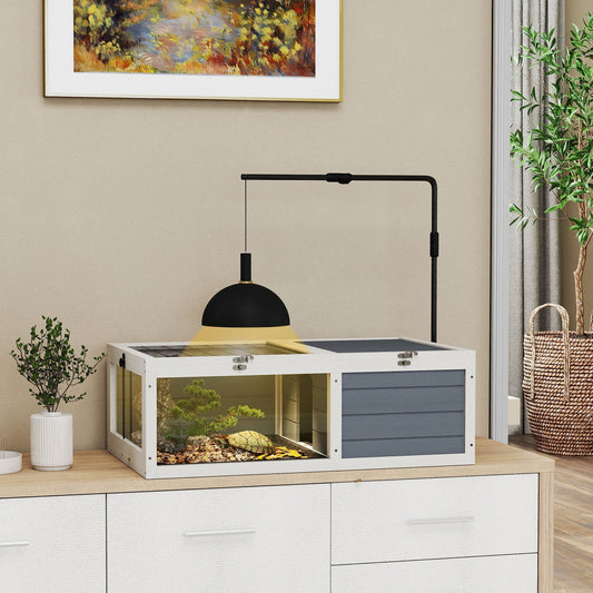 The reptile house is shown in a room with a tortoise inside, featuring an adjustable lamp holder and a grey wooden exterior