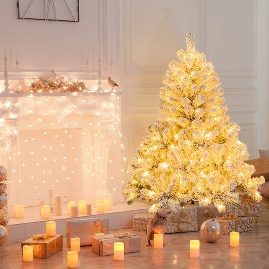 The flocked Christmas tree is lit up and decorated with baubles, standing in a festive room setting