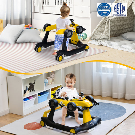 A baby sits in the yellow baby walker in a room with toys and a tent
