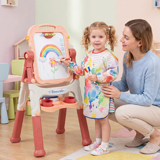 The art easel being used by a young girl drawing on the whiteboard with her mother watching
