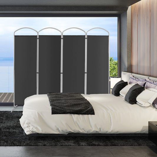 The grey room divider is set up in a modern bedroom behind a bed