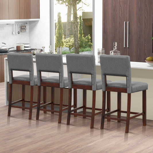 Four grey bar stools with rubber wood legs arranged at a kitchen counter