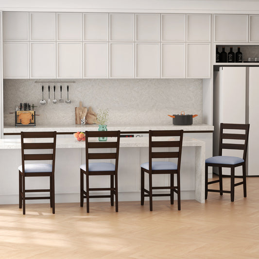 The bar stools arranged in a row along a modern kitchen island counter