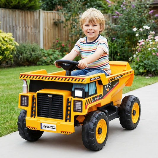 A young boy happily driving the yellow and black kids electric car around a garden path