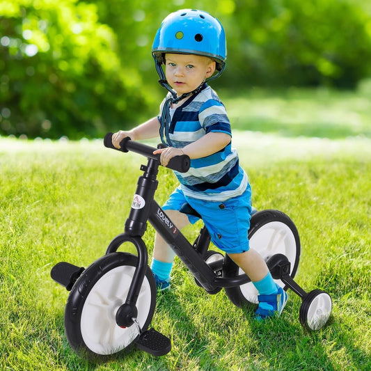 A young boy wearing a blue helmet riding the kids balance bike on a green grassy lawn
