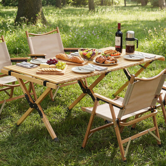 The folding camping table set up with food and chairs in a garden