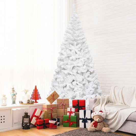 The white artificial Christmas tree decorated with presents and a teddy bear in a living room setting