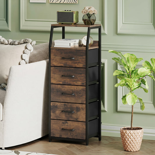 The storage cabinet is placed in a living room next to a sofa and a potted plant