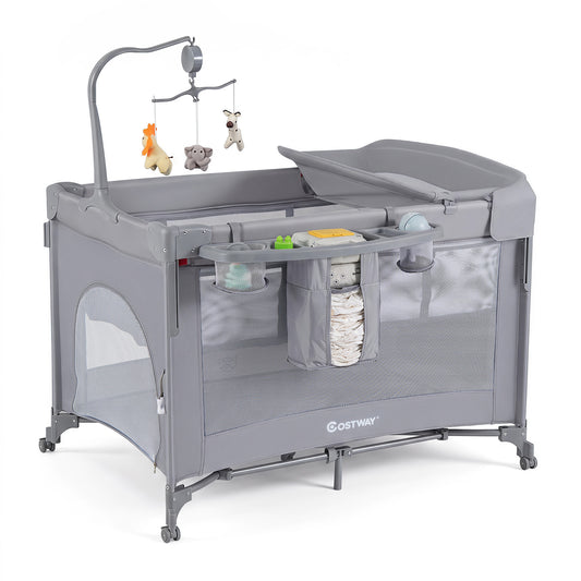 The grey bassinet and bedside sleeper is shown with its changing table attachment and mobile