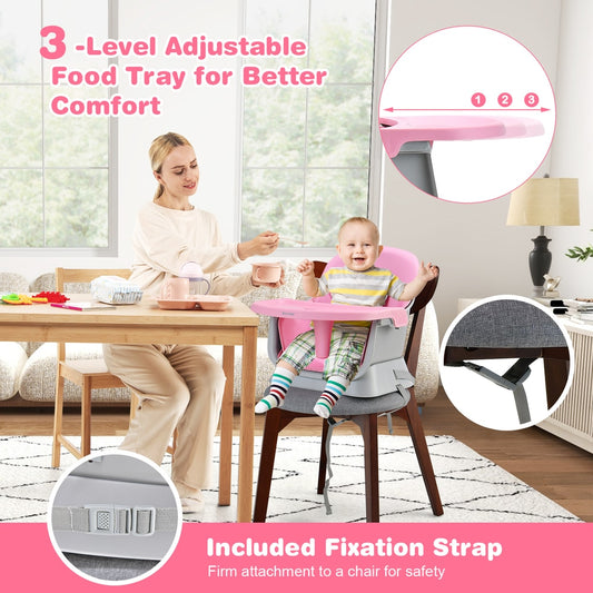 A mother feeding a baby in the pink high chair at a dining table