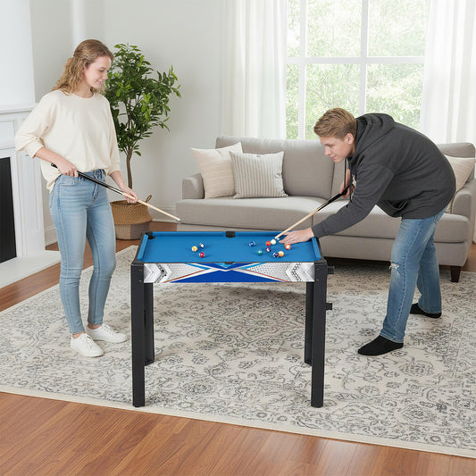 Two people playing billiards on the blue game table in a bright living room setting