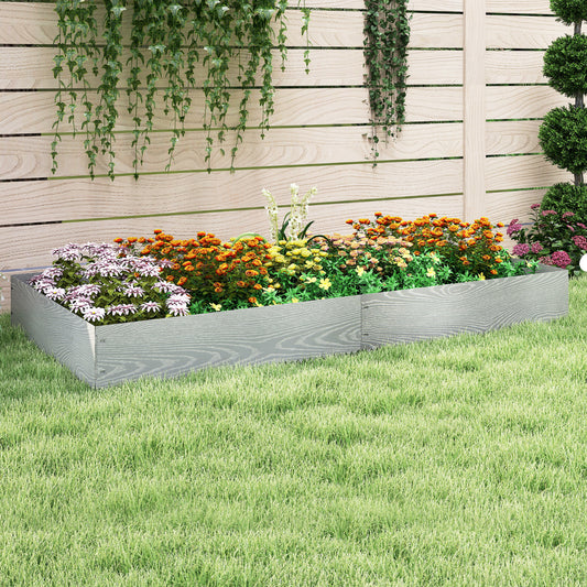 Two sections of the galvanised raised garden bed installed on a lawn with flowers