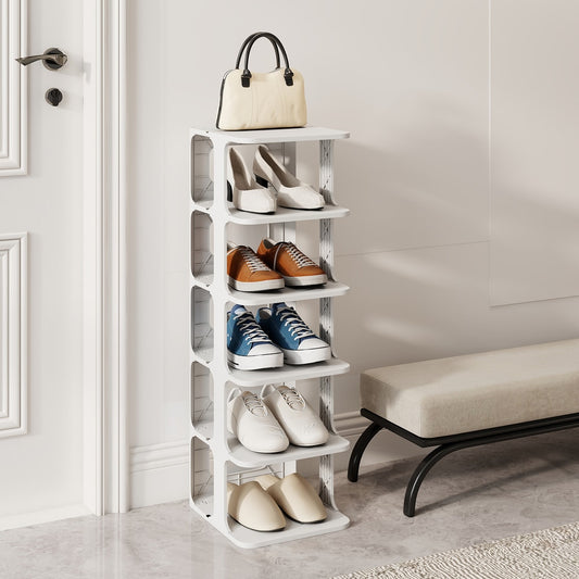 White shoe rack with shoes and a handbag on top, shown in a hallway next to a bench