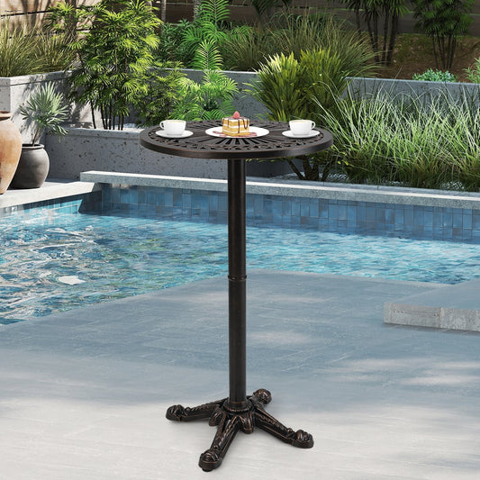 The patio table is placed next to a swimming pool on a paved area with plants in the background