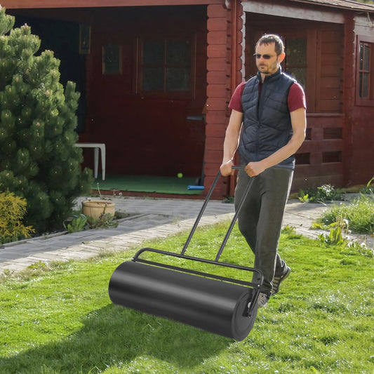 A man uses the heavy-duty garden grass roller on a lawn next to a wooden shed