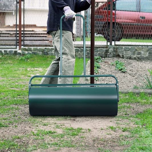 Person using the heavy-duty garden grass roller on uneven ground