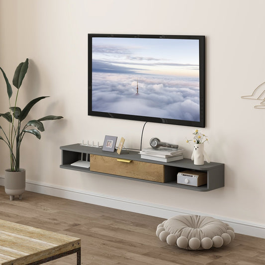 The floating TV stand in charcoal grey with a drawer and open shelves, mounted on a wall