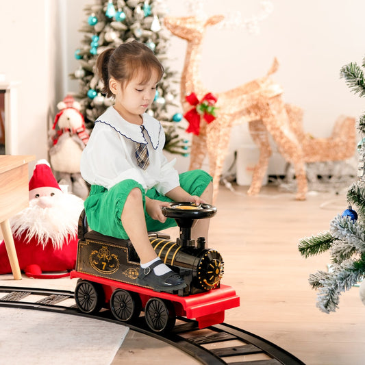 The electric train being ridden by a young girl in a festive indoor setting