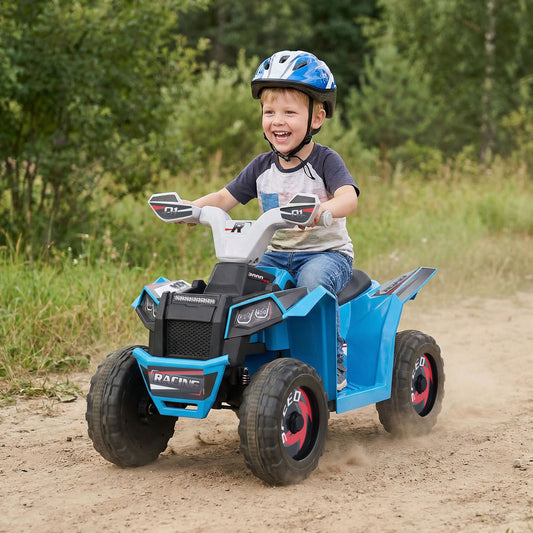 Young boy riding the blue kids electric quad with trailer on a dirt track