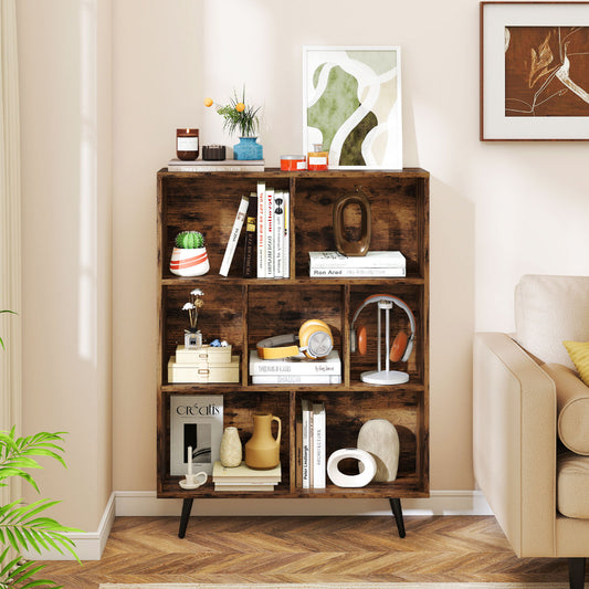 The bookcase in a living room setting with books and decorative items on the shelves