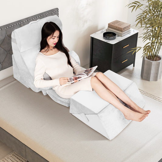 The adjustable support pillow set in use on a bed with a woman reading