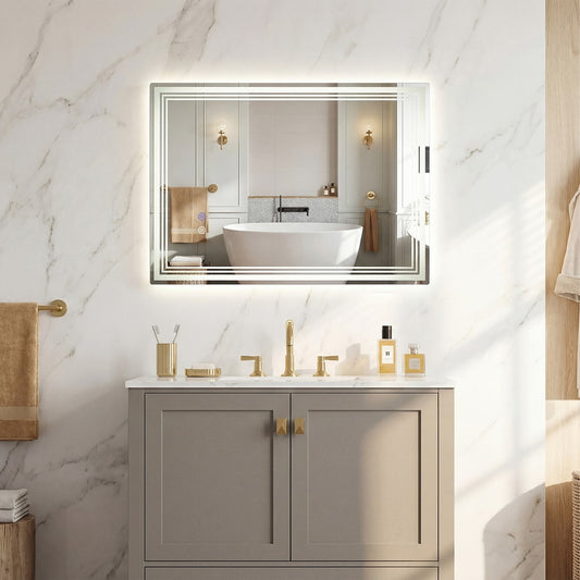 The wall mirror mounted above a bathroom vanity unit in a marble tiled room