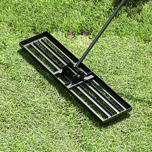 The lawn leveling tool resting on a patch of green grass