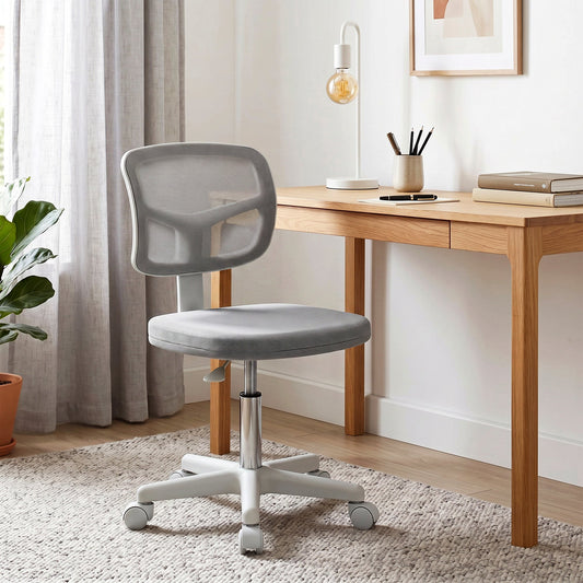 The office chair placed in a bright home study next to a wooden desk and a house plant