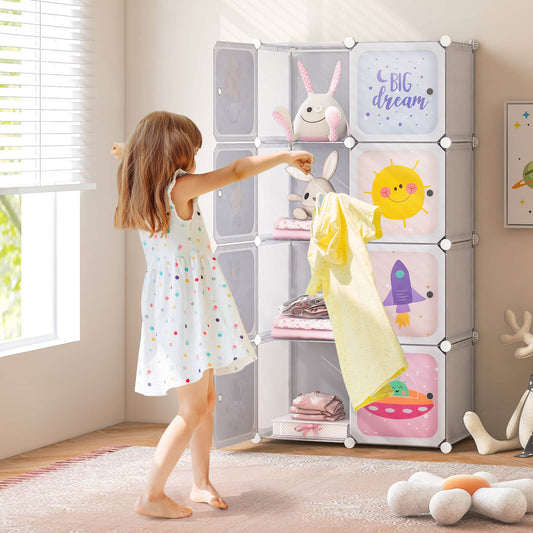 A young girl puts a yellow t-shirt into the white kids storage cubes