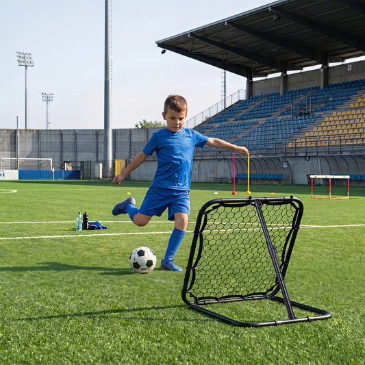Young boy practices football skills with the rebounder on a sports field