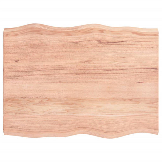 A close-up of the light brown live edge table top showing the natural wood grain