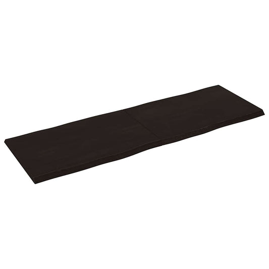 the dark brown table top viewed from an elevated angle showing the live edge detail