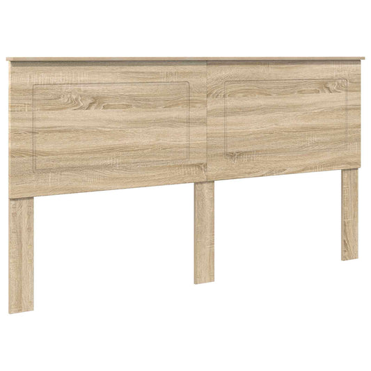 The headboard is made of engineered wood with a sonoma oak finish and two panelled sections