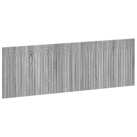 The wall headboard shown from a high angle to display the grey wood grain and arched pattern