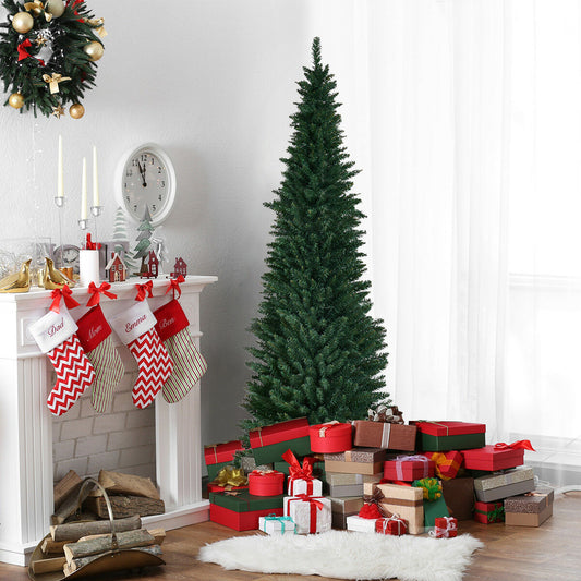 The slim christmas tree placed in a living room next to a fireplace with stockings and gifts