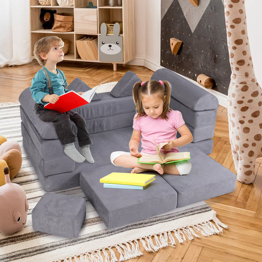 Two children reading books on the modular kids play couch in a room