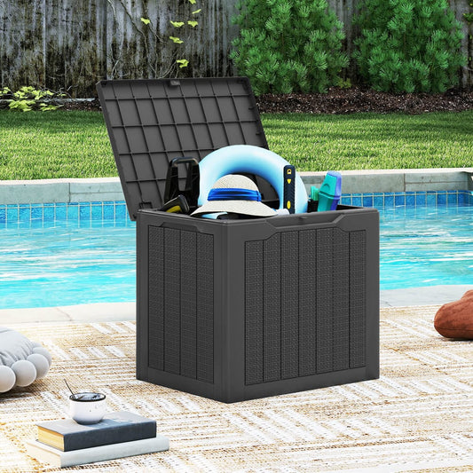 The outdoor storage box filled with pool accessories next to a swimming pool