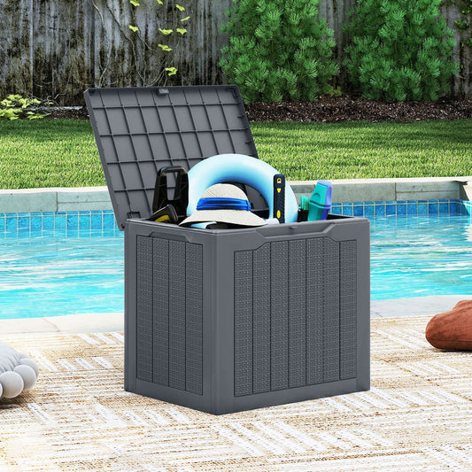 The outdoor storage box is shown next to a swimming pool filled with pool accessories