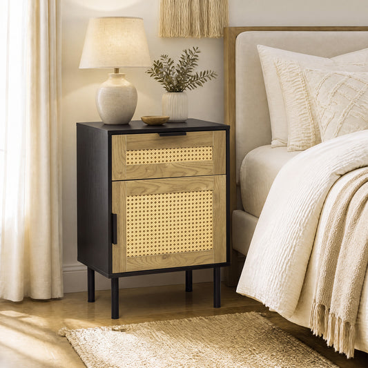 The black bedside table with rattan drawer and door in a bedroom setting