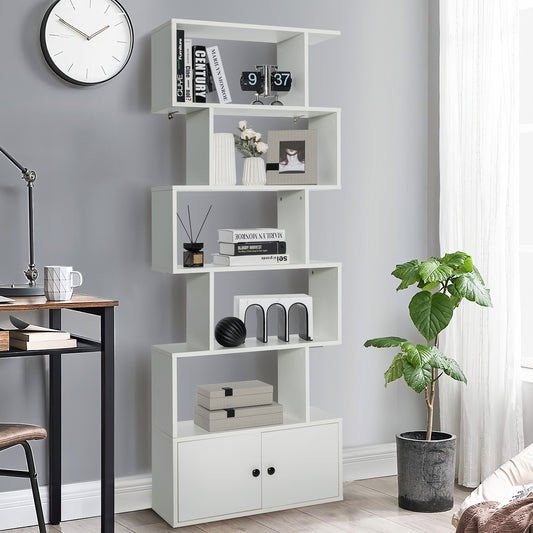 The white bookcase styled with books and decor in a modern home office setting