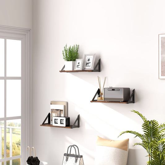 The floating shelves mounted on a white wall in a living room with home decor items