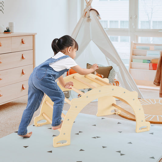 A young child climbs on the wooden arch accessory of the climbing frame in a bright room